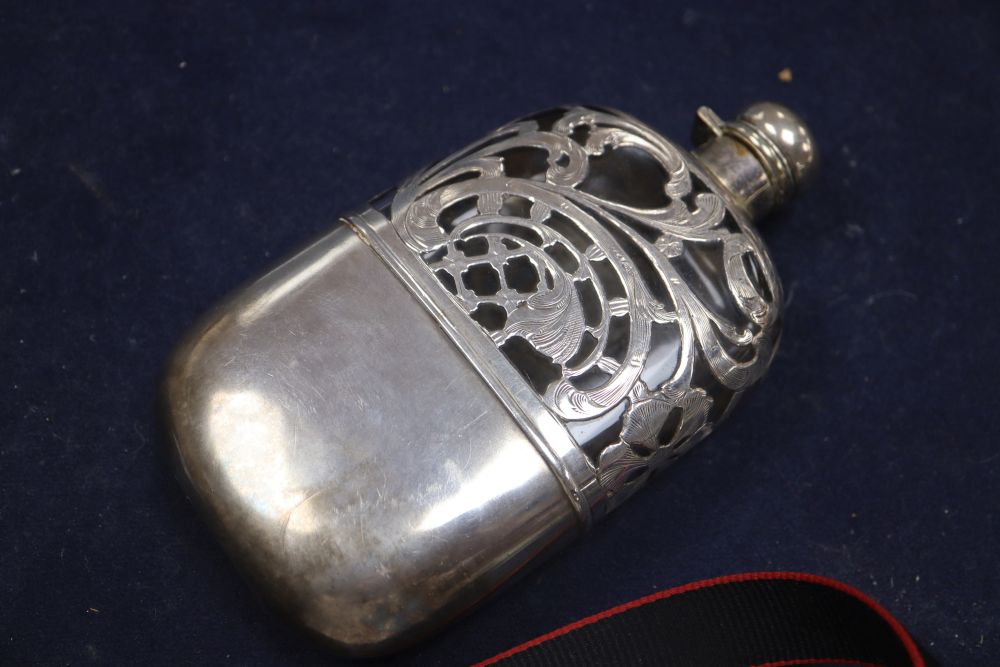 A white metal overlaid glass hip flask, with white metal cup and engraved monogram, 16.7cm.